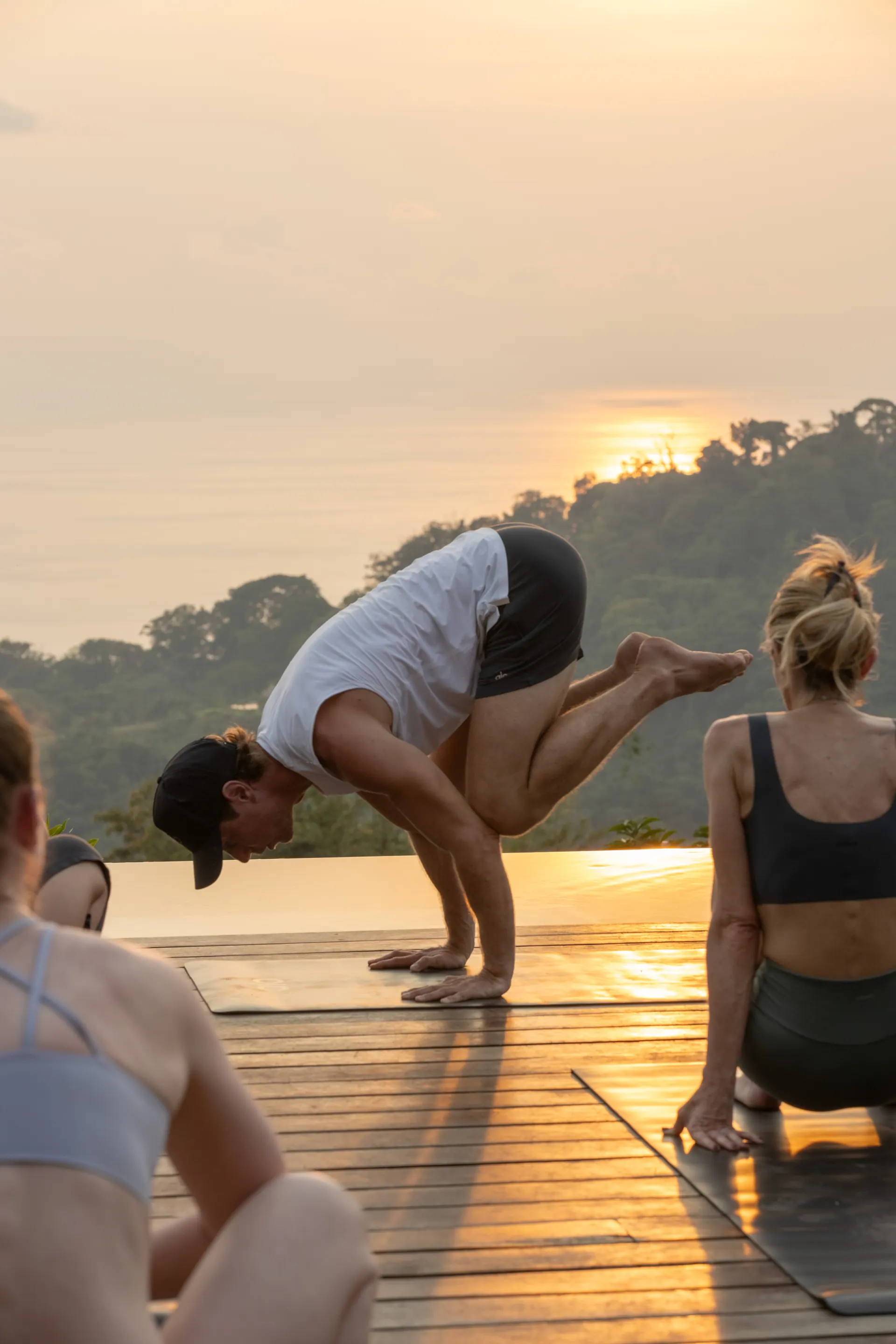 Sunset practice above the jungle, hands sweeping overhead