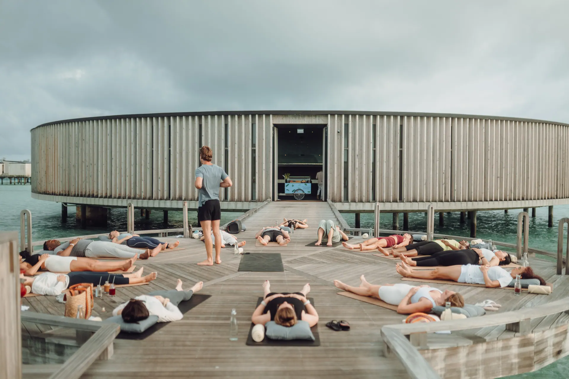 Savasana rows on an ocean deck at dusk
