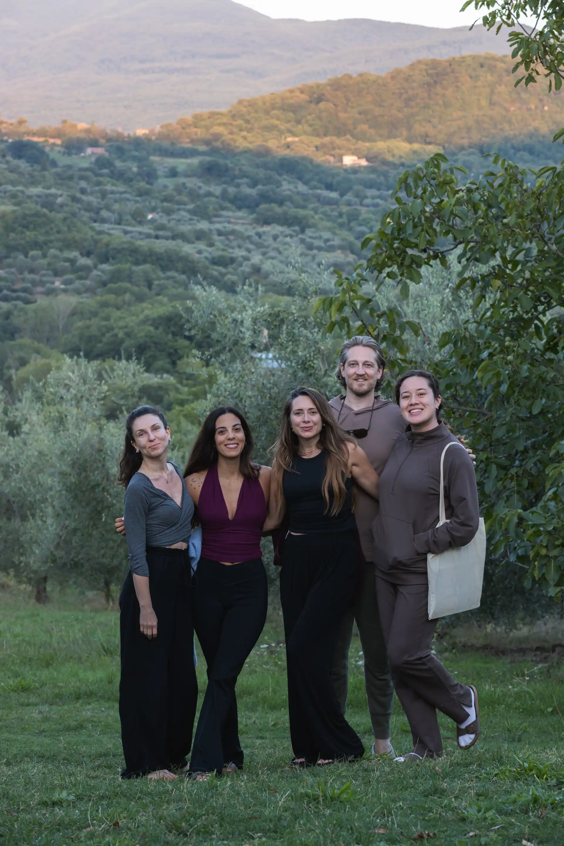 A training cohort gathered between vineyard rows in Tuscany